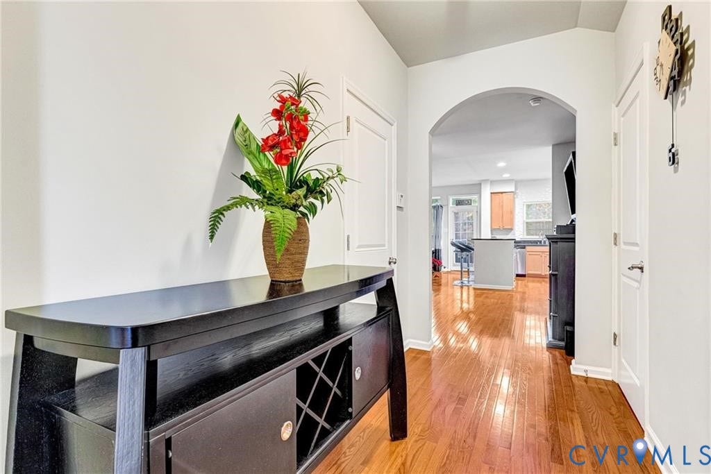 11600 Vicars Ridge Lane, Henrico, VA 23059 Corridor featuring light wood-style floors, arched walkways, and baseboards