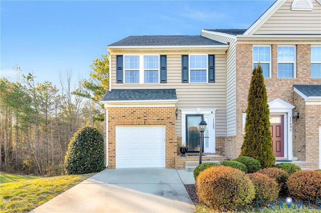 11600 Vicars Ridge Lane, Henrico, VA 23059 View of front of house with concrete driveway, a garage, brick siding, and a shingled roof