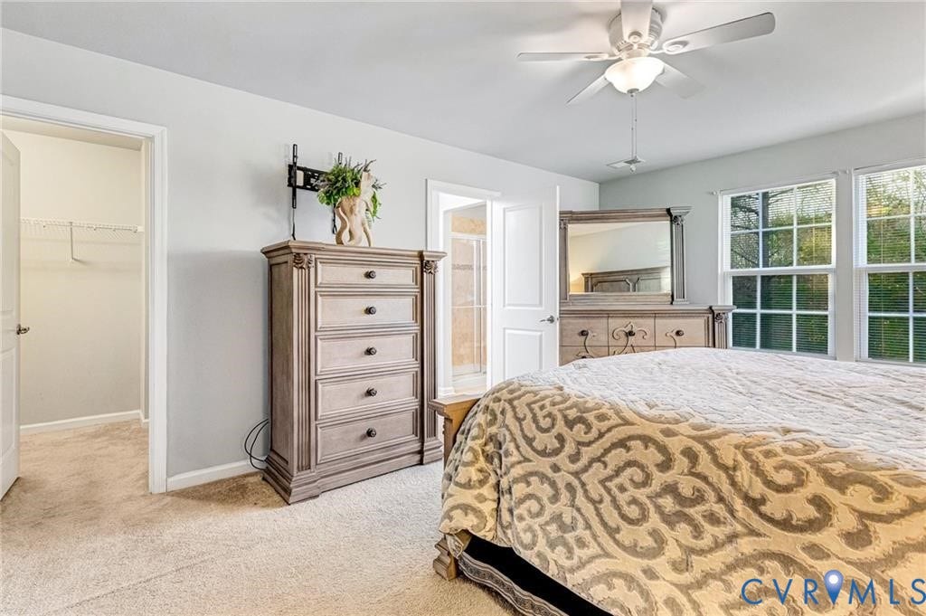 11600 Vicars Ridge Lane, Henrico, VA 23059 Bedroom featuring a spacious closet, baseboards, light colored carpet, a closet, and a ceiling fan