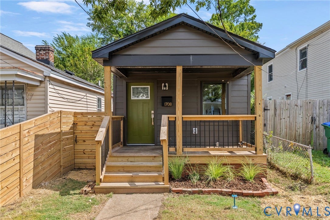 1708 Decatur Street, Swansboro, Richmond, VA 23224 Dark-toned lap siding exterior featuring a covered front porch with natural wood posts, iron railing, and a vibrant green front door