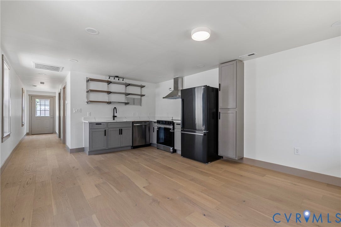 1708 Decatur Street, Swansboro, Richmond, VA 23224 Kitchen featuring wood-finish flooring, grey cabinetry, solid-surface countertops, open metal shelving, and stainless steel appliances