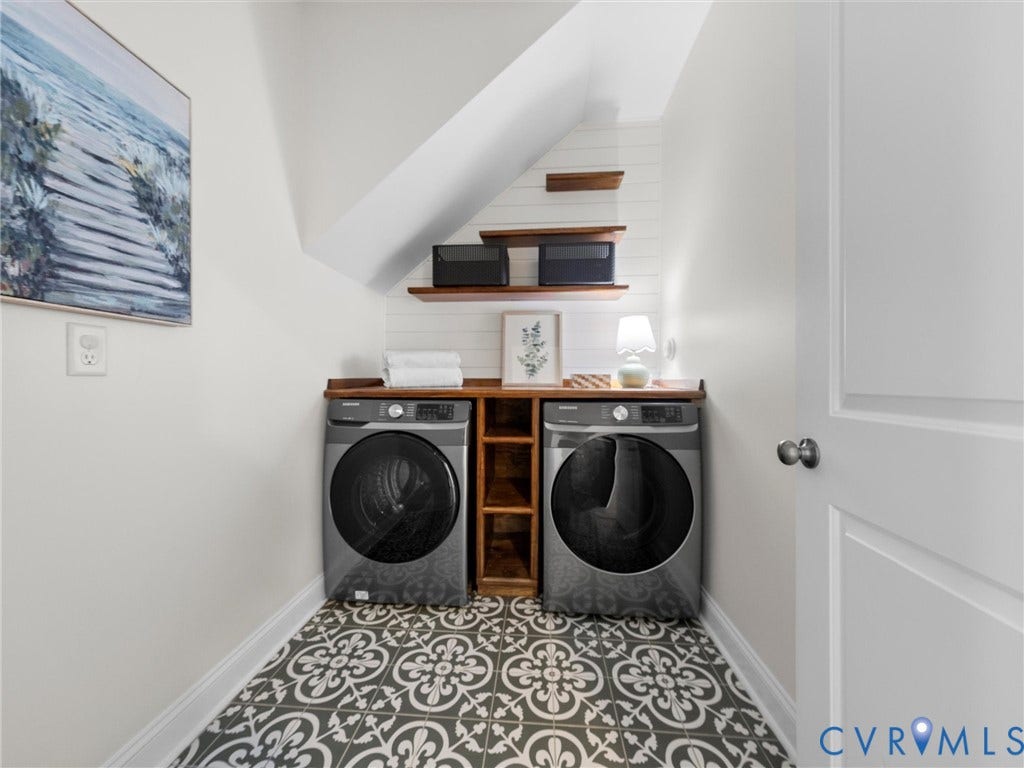 1412 Ascot Hill Terrace, Midlothian, VA 23112 Laundry area featuring patterned tile flooring, built-in wooden shelving, shiplap wall accent, and a custom wood countertop over laundry appliance space