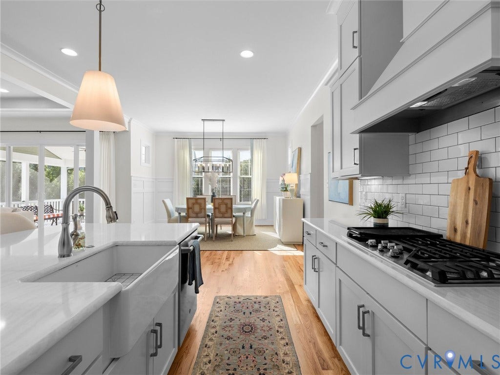 1412 Ascot Hill Terrace, Midlothian, VA 23112 Kitchen featuring a white farmhouse sink, light-toned quartz countertops, subway tile backsplash, ceiling-height cabinetry, and wood-finish flooring