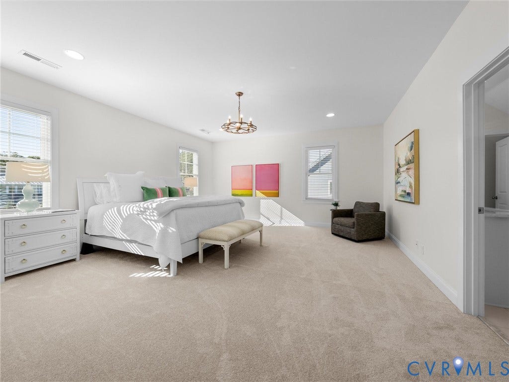 1412 Ascot Hill Terrace, Midlothian, VA 23112 Spacious room featuring neutral carpeting, multi-pane windows, recessed lighting, and a tiered metal chandelier