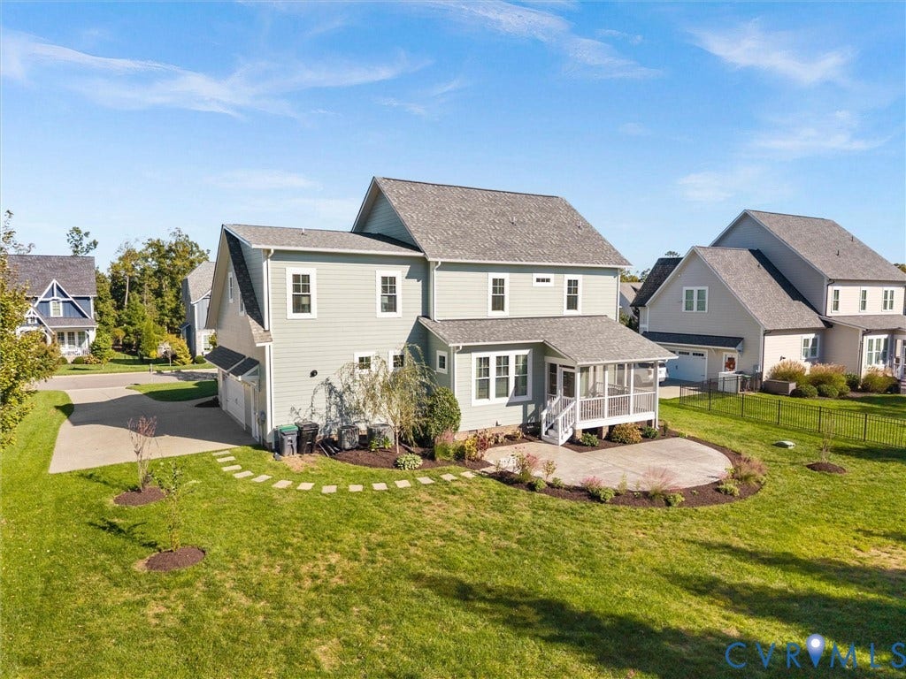 1412 Ascot Hill Terrace, Midlothian, VA 23112 Two-story residence featuring light-toned lap siding, a rear covered porch, a curved concrete patio, and an expansive lawn
