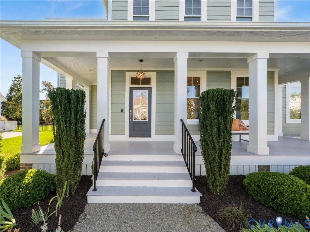 1412 Ascot Hill Terrace, Midlothian, VA 23112 Covered front porch featuring white square columns, light green horizontal siding, multi-pane glass entry door, and black metal handrails