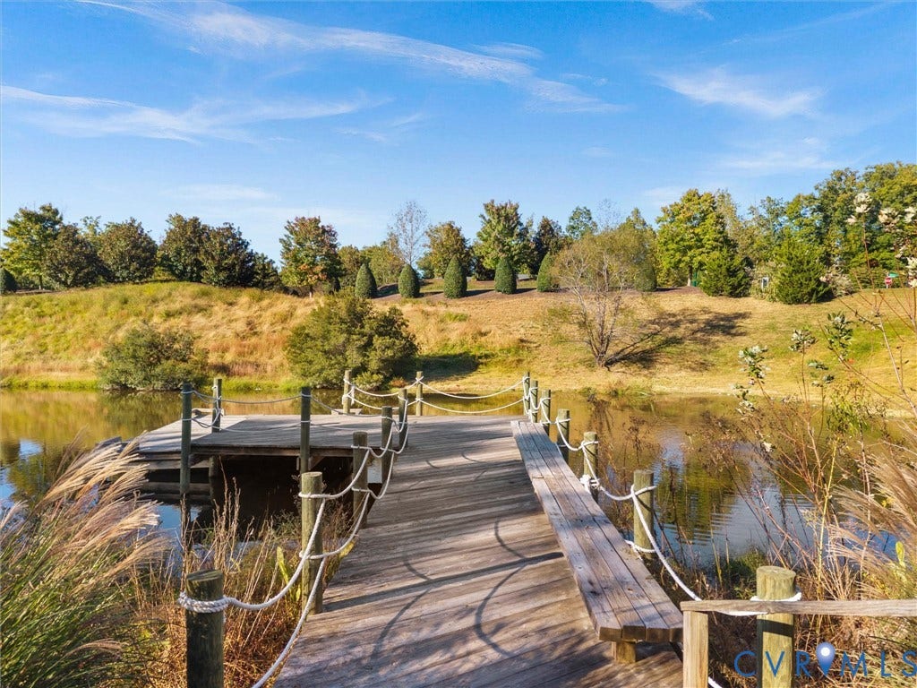 1412 Ascot Hill Terrace, Midlothian, VA 23112 Wooden dock featuring integrated bench seating and rope-style handrails extending over a private pond with landscaped shoreline