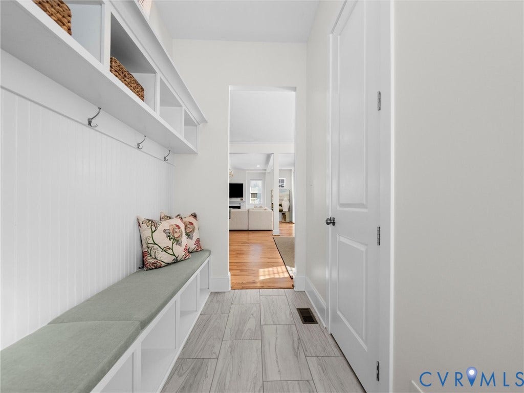 1412 Ascot Hill Terrace, Midlothian, VA 23112 Mudroom featuring built-in cabinetry with beadboard detailing, open cubby storage, integrated bench seating, and wood-finish flooring in the adjoining space
