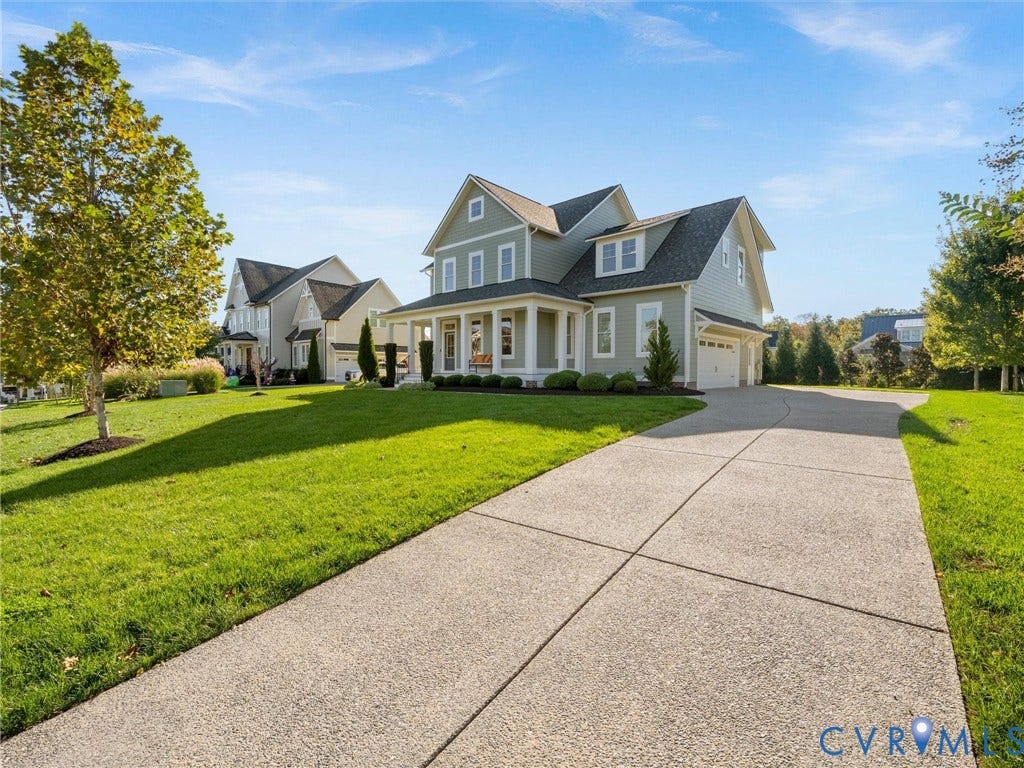 1412 Ascot Hill Terrace, Midlothian, VA 23112 Two-story residence featuring light-colored horizontal siding, a covered front porch with white columns, gabled rooflines, and a concrete driveway leading to a multi-car garage
