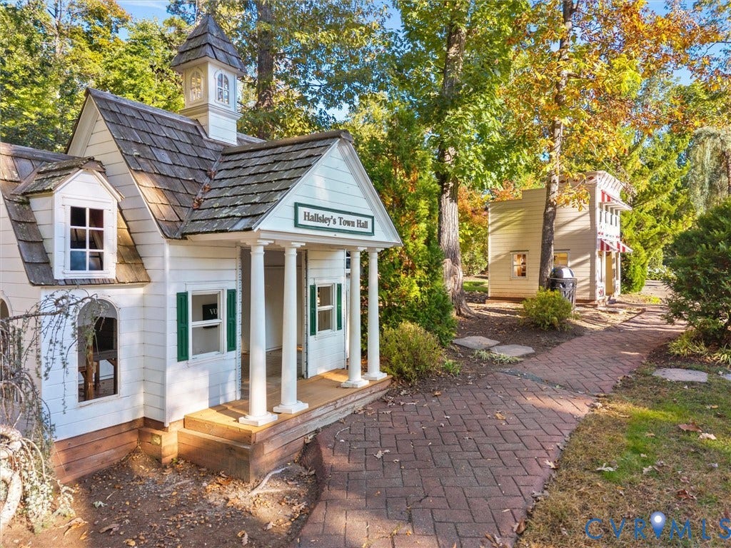1412 Ascot Hill Terrace, Midlothian, VA 23112 Miniature exterior structure featuring white horizontal siding, a cedar-shake roof with a cupola, a front portico with classical columns, and herringbone-patterned brick hardscaping