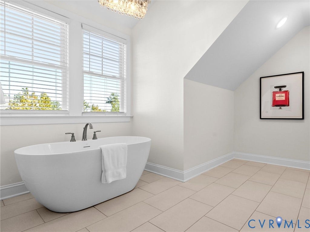 1412 Ascot Hill Terrace, Midlothian, VA 23112 Freestanding white soaking tub with deck-mounted chrome faucet, large-format tile flooring, double windows, and recessed ceiling lighting