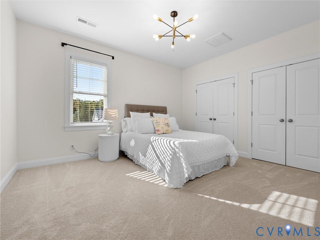 1412 Ascot Hill Terrace, Midlothian, VA 23112 Neutral-toned carpeting, multi-pane window, modern multi-arm chandelier, and double-panel closet doors