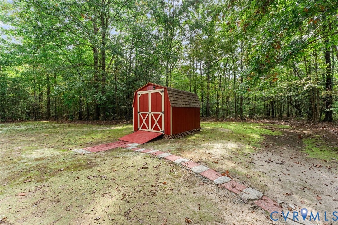 17030 Courtney Road, Reedy Church District, Hanover, VA 23069 Gambrel-roof storage shed featuring double-door entry, a ramp, and a stone-paver walkway situated on a wooded lot