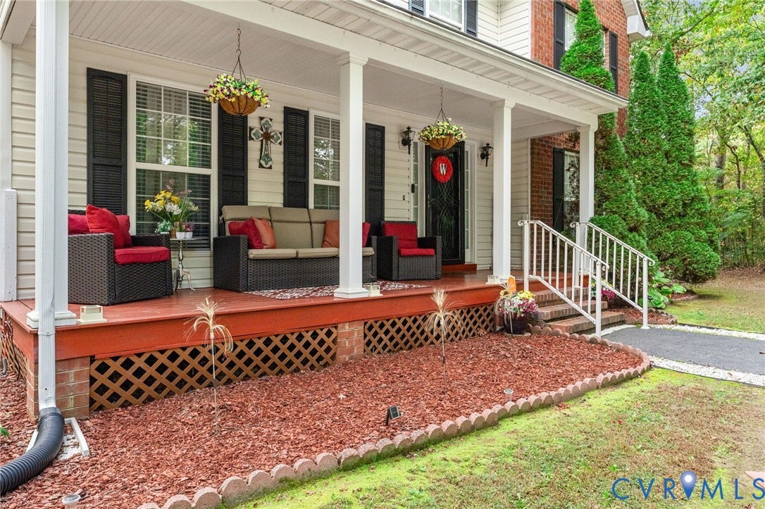 17030 Courtney Road, Reedy Church District, Hanover, VA 23069 Covered front porch featuring a painted wood deck, lattice skirting, white support columns, and white metal railing