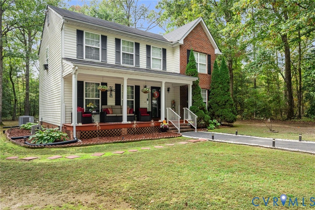 17030 Courtney Road, Reedy Church District, Hanover, VA 23069 Two-story residence featuring a brick and vinyl-sided exterior, a covered front porch with lattice skirting, and a paved driveway