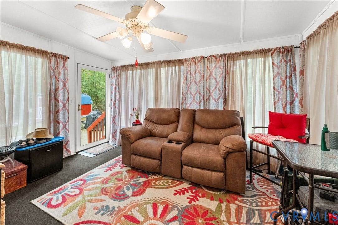 17030 Courtney Road, Reedy Church District, Hanover, VA 23069 Enclosed space featuring expansive window walls, a ceiling-mounted light fixture with a multi-blade fan, and a glass-paneled exterior door