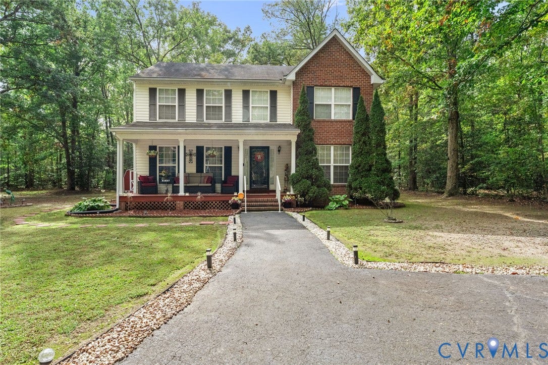 17030 Courtney Road, Reedy Church District, Hanover, VA 23069 Two-story exterior featuring a brick and siding facade, expansive front porch with railing, and asphalt driveway