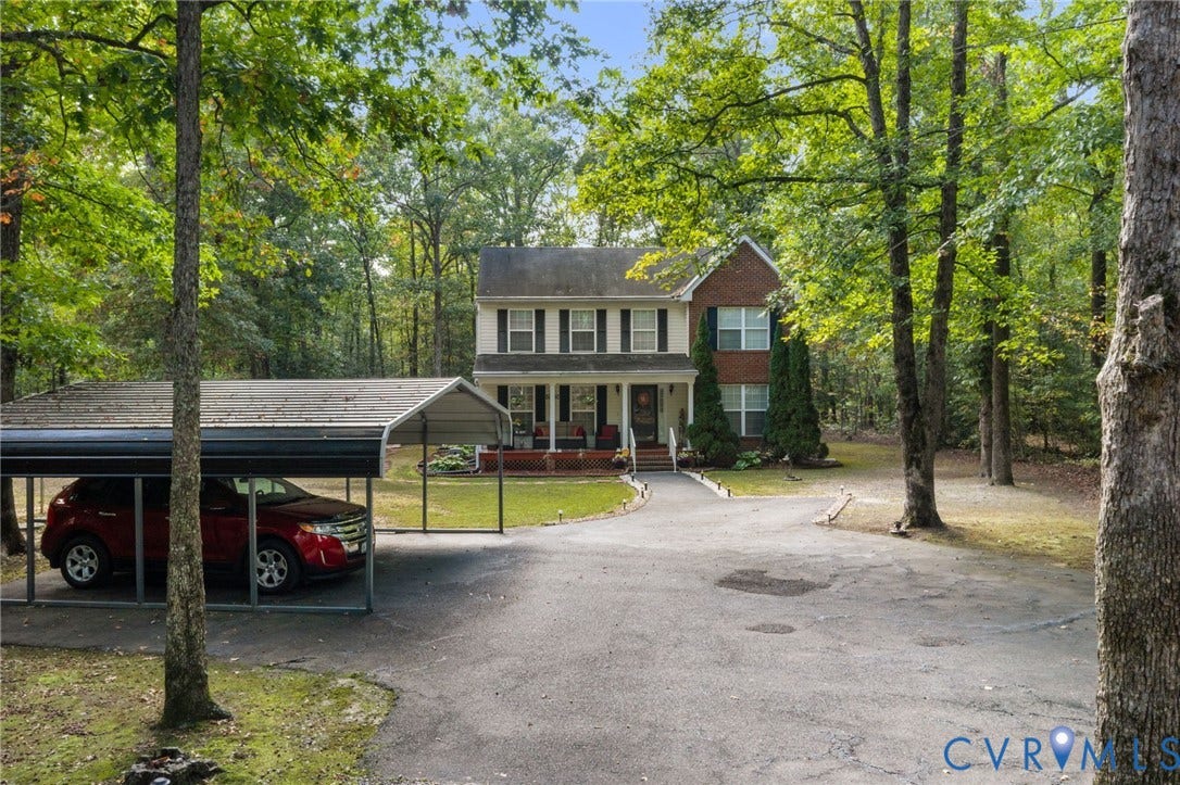 17030 Courtney Road, Reedy Church District, Hanover, VA 23069 Two-story brick and siding colonial exterior featuring a front porch, an asphalt driveway, and a detached metal carport