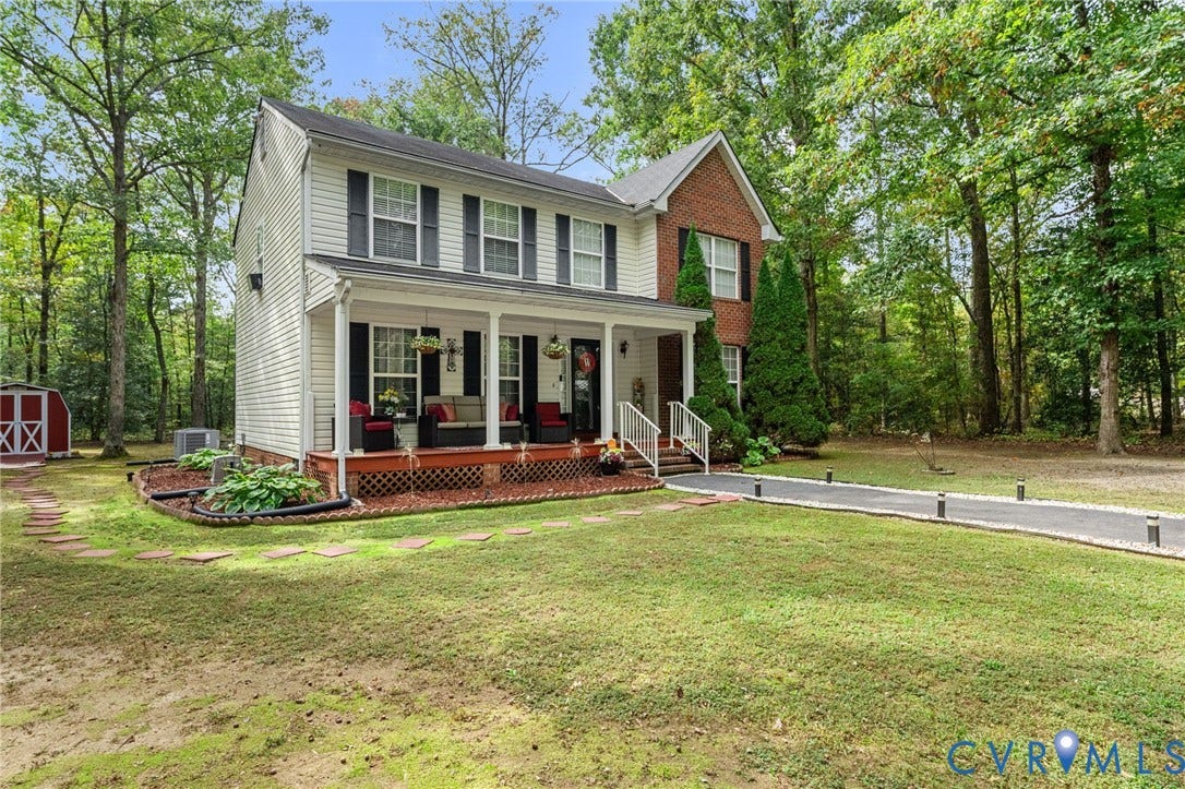 17030 Courtney Road, Reedy Church District, Hanover, VA 23069 Two-story residence featuring a combination of brick and siding exterior, a covered front porch with lattice skirting, and an asphalt driveway