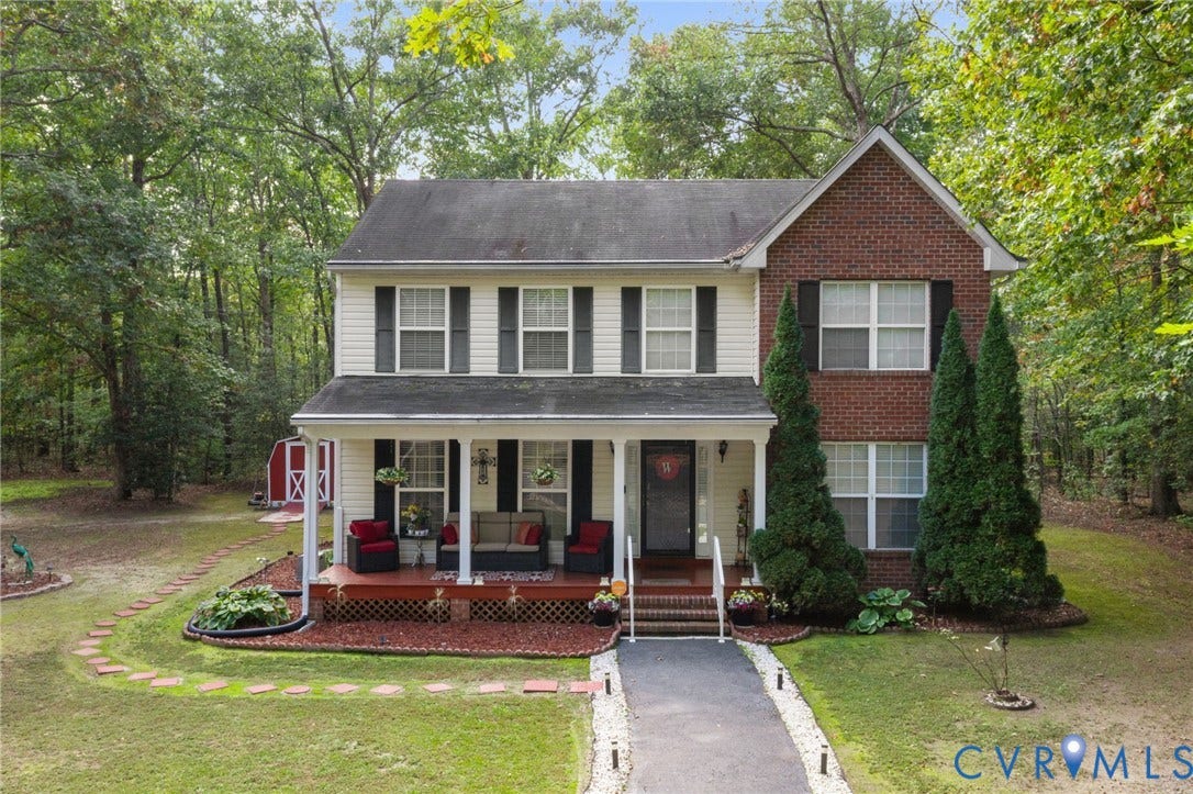 17030 Courtney Road, Reedy Church District, Hanover, VA 23069 Two-story exterior featuring a partial brick faade, light-toned siding, covered front porch, and a dedicated storage shed