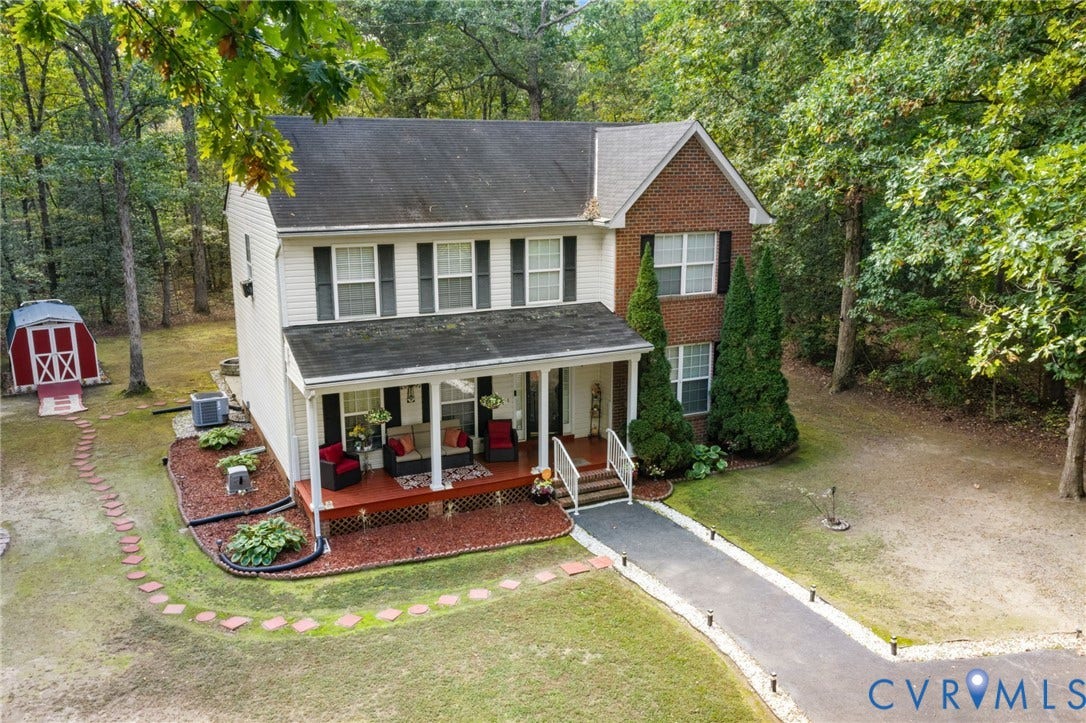 17030 Courtney Road, Reedy Church District, Hanover, VA 23069 Two-story exterior featuring a brick and siding facade, covered front porch with columns, asphalt shingle roof, stone walkway, and detached storage structure