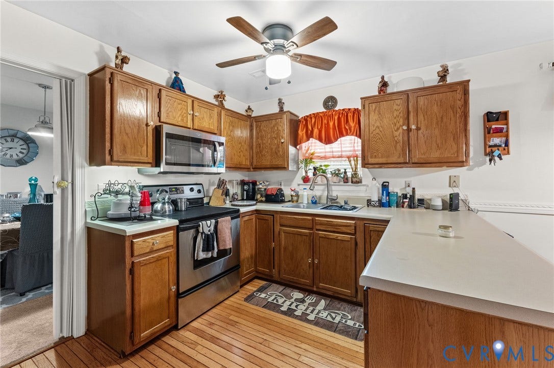 17030 Courtney Road, Reedy Church District, Hanover, VA 23069 Kitchen featuring wood cabinetry, stainless steel appliances, neutral countertops, wood-finish flooring, and a ceiling fan with integrated lighting