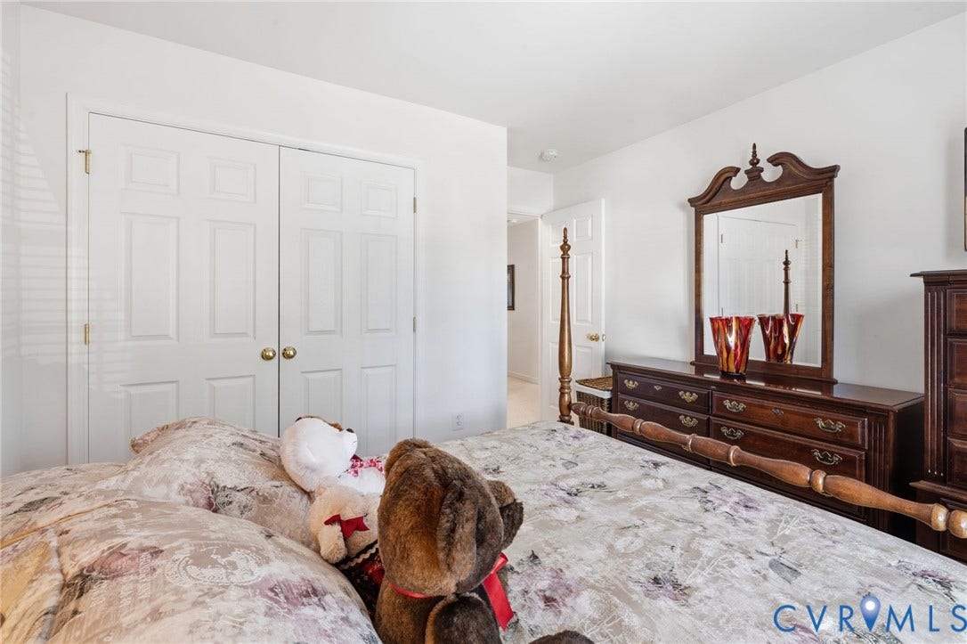 621 Scotter Hills Court, Midlothian, VA 23114 Double-door reach-in closet featuring white panel doors and brass hardware