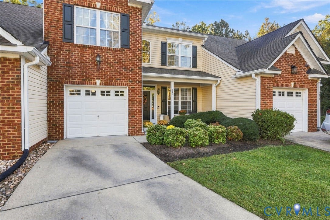 621 Scotter Hills Court, Midlothian, VA 23114 Multi-level exterior featuring a combination of brick and siding, dual attached garages, a covered front entryway, and manicured landscaping