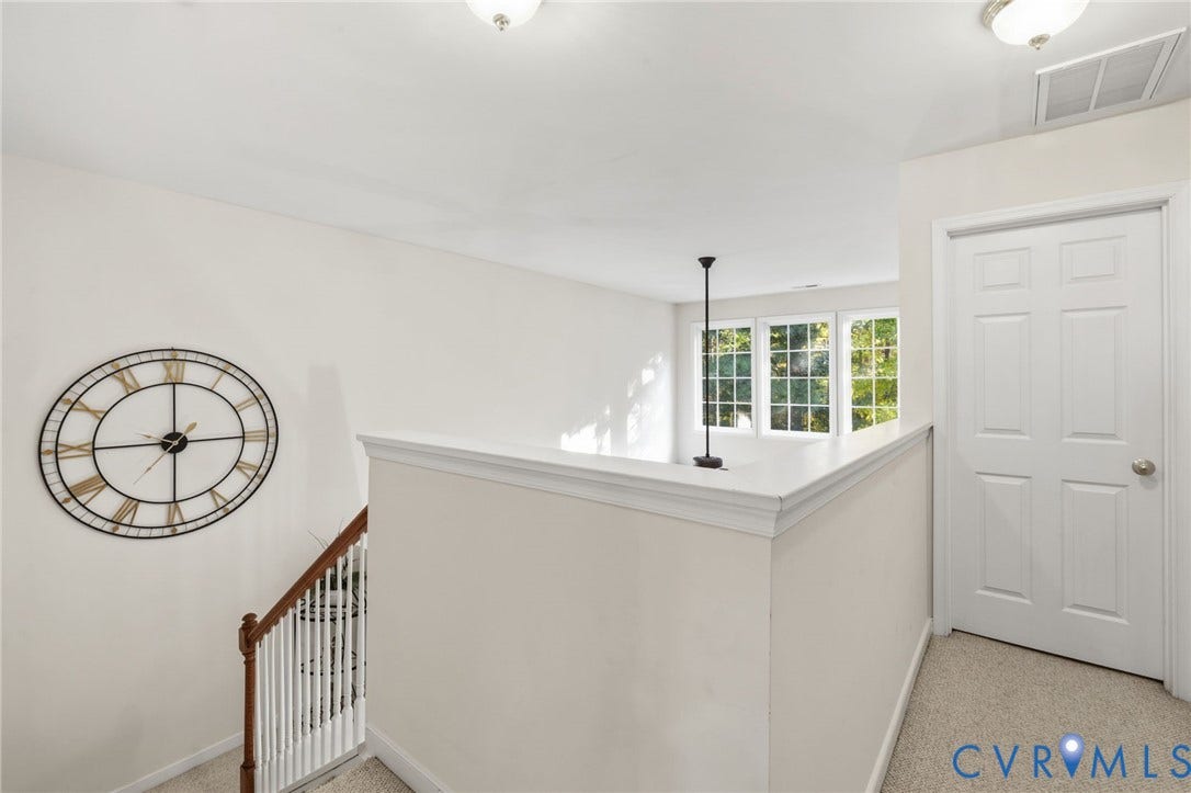 621 Scotter Hills Court, Midlothian, VA 23114 Neutral-toned interior featuring carpeting, a white paneled door, and a staircase with a wooden handrail and white balusters