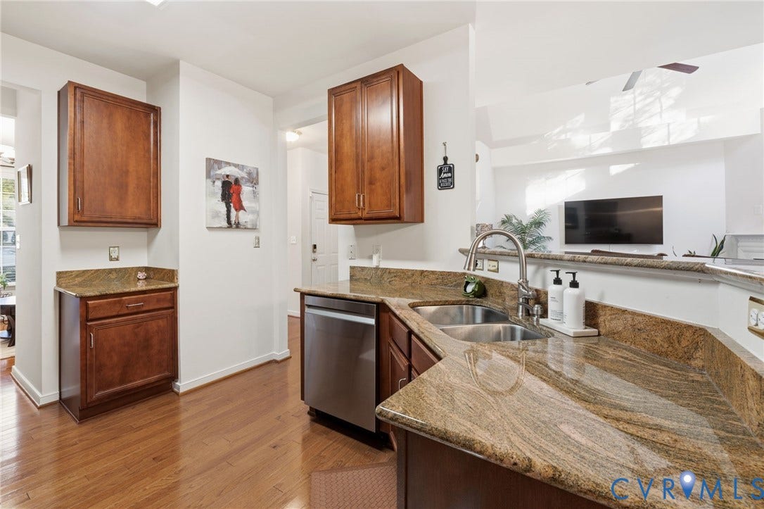 621 Scotter Hills Court, Midlothian, VA 23114 Kitchen featuring stained wood cabinetry, stone-surface countertops, wood-finish flooring, and a stainless steel dishwasher with a dual-basin undermount sink