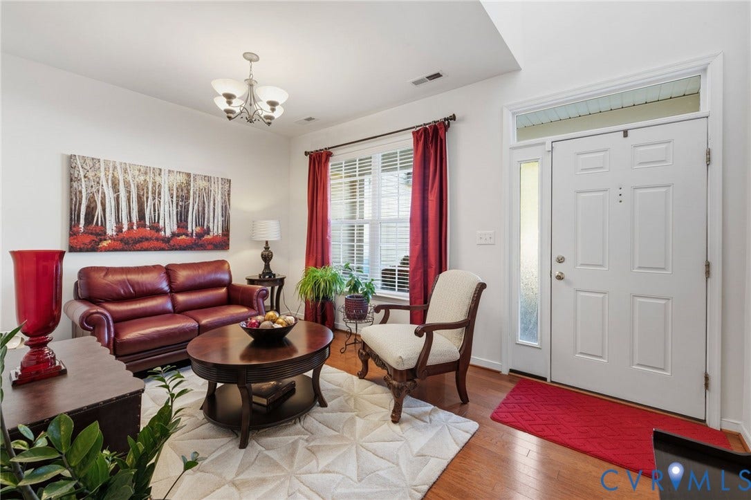 621 Scotter Hills Court, Midlothian, VA 23114 Foyer and room featuring wood-finish flooring, a multi-light chandelier, a multi-paneled entry door with side light and transom window, and a window with wood blinds