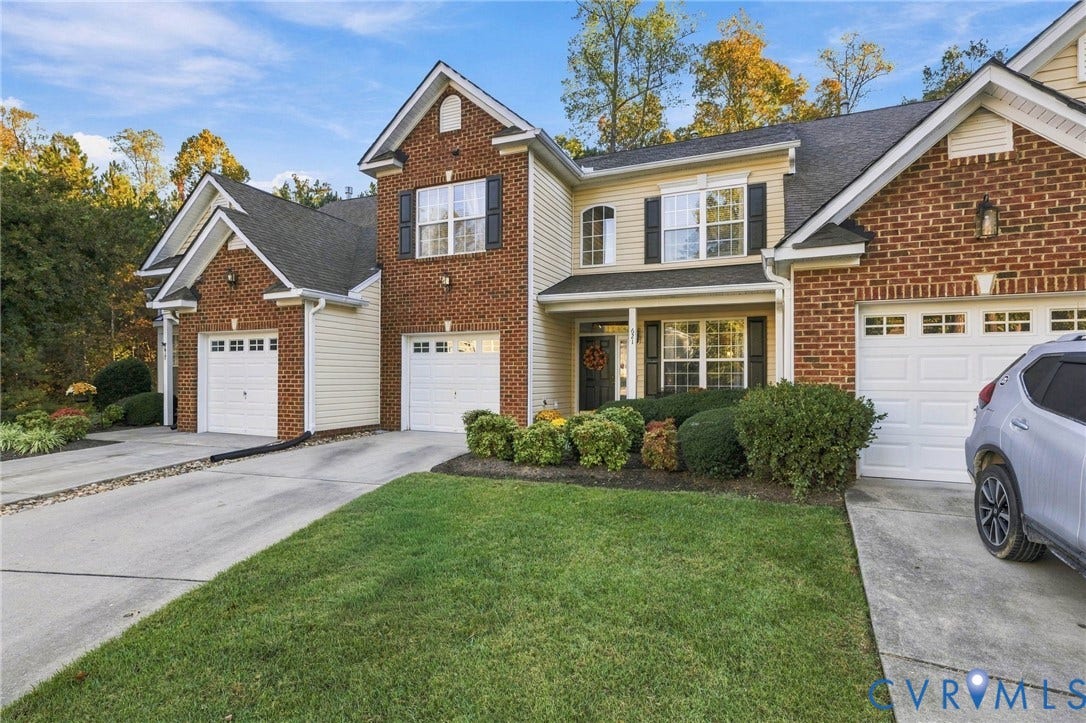 621 Scotter Hills Court, Midlothian, VA 23114 Multi-unit residential exterior featuring a combination brick and vinyl siding facade, pitched shingle roofing, and multiple private garage bays with concrete driveways