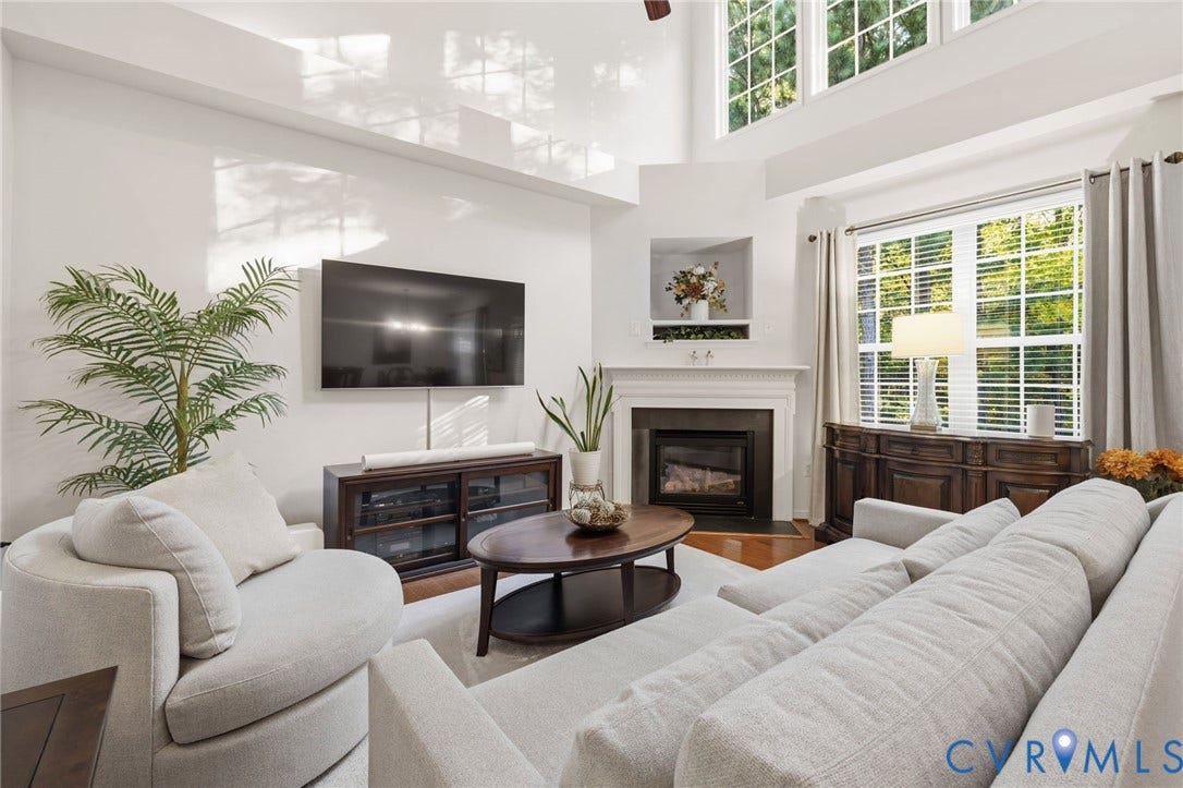 621 Scotter Hills Court, Midlothian, VA 23114 Living area featuring a high vaulted ceiling, fireplace with a mantel, built-in wall niche, oversized windows, and wood-finish flooring