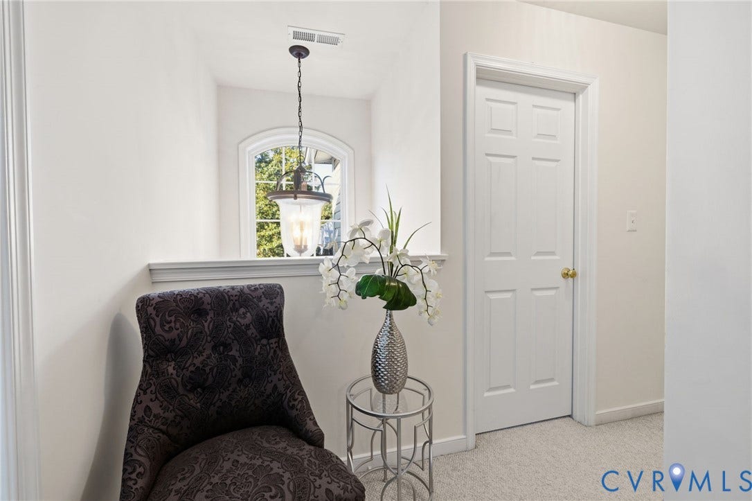 621 Scotter Hills Court, Midlothian, VA 23114 Arched window with decorative casing, six-panel interior door, and hanging pendant light fixture