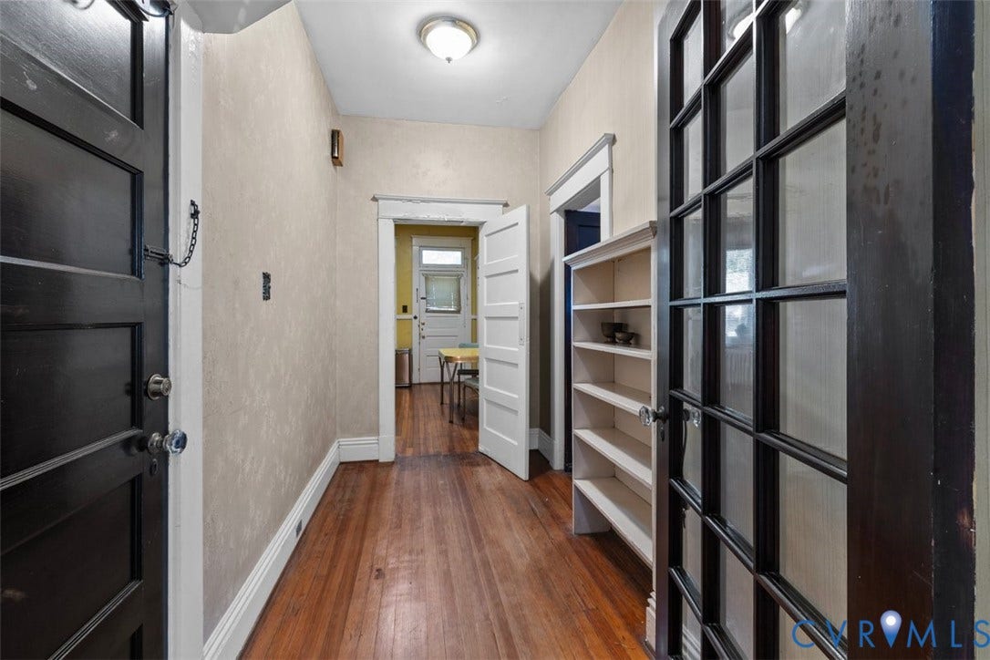 210 W Graham Road, Richmond, VA 23222 Entryway featuring wood-finish flooring, dark-finish paneled doors, multi-pane glass French doors, and built-in shelving