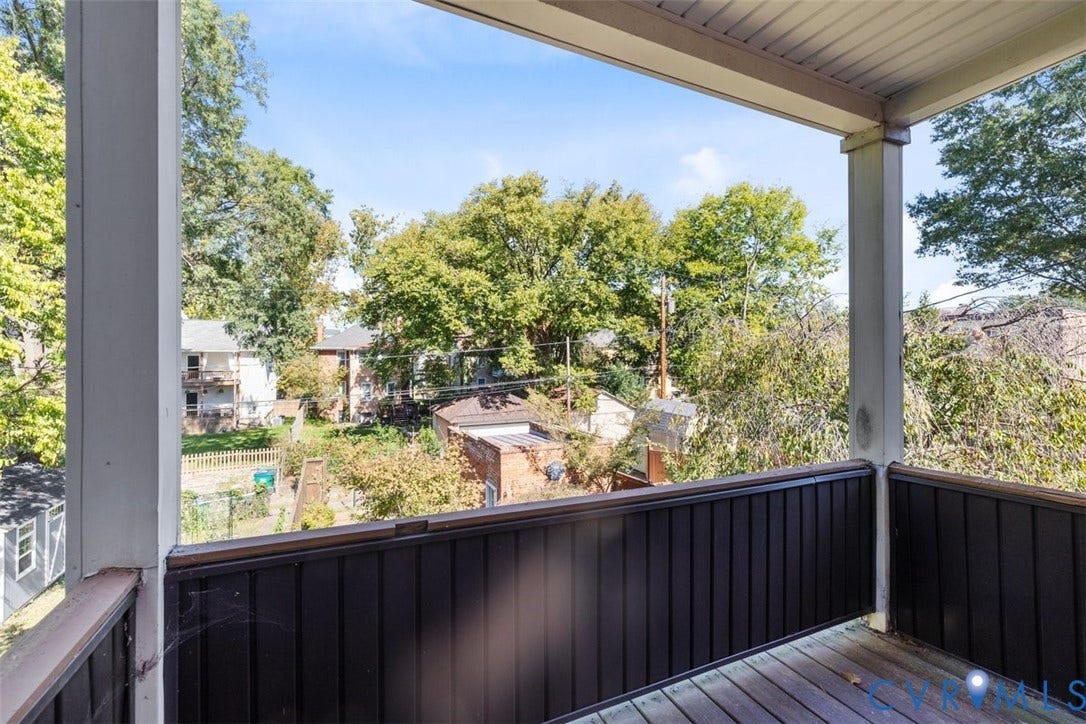 210 W Graham Road, Richmond, VA 23222 third bedroom covered outdoor balcony featuring wood-finish decking and vertical slat railing.
