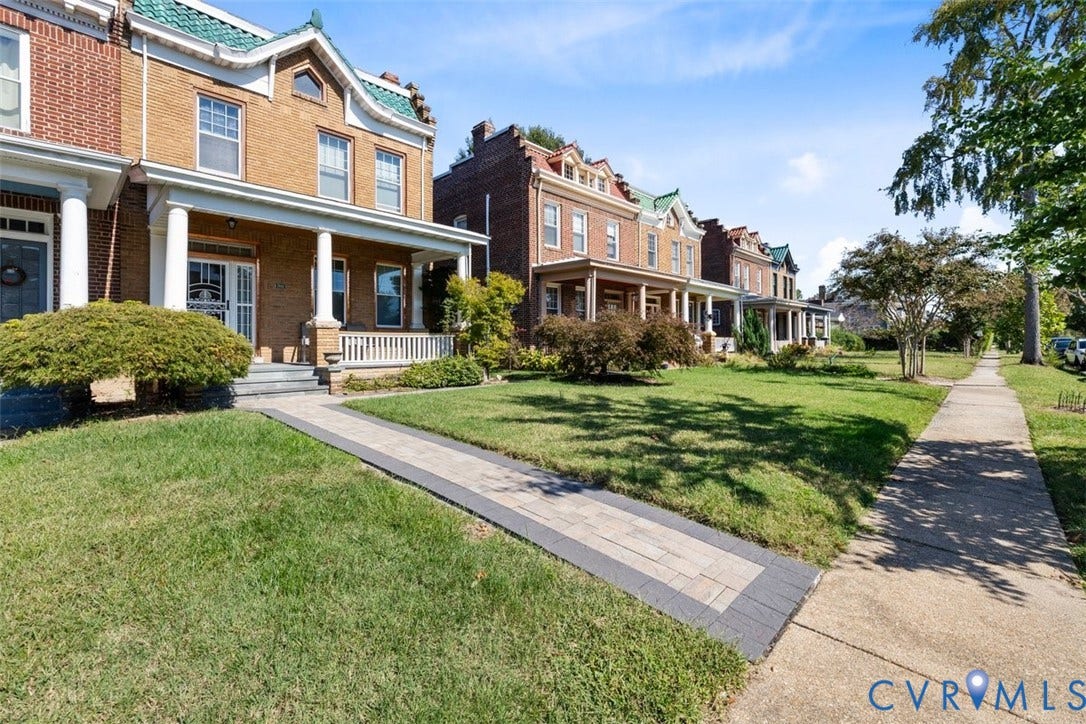 210 W Graham Road, Richmond, VA 23222 Brick exterior featuring a covered front porch, white columns, decorative roofline gables, and a stone-paver walkway