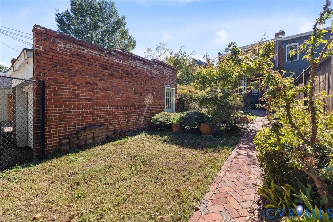 210 W Graham Road, Richmond, VA 23222 Exterior grounds featuring a brick-paved pathway, a brick-facade structure, and mature landscaping