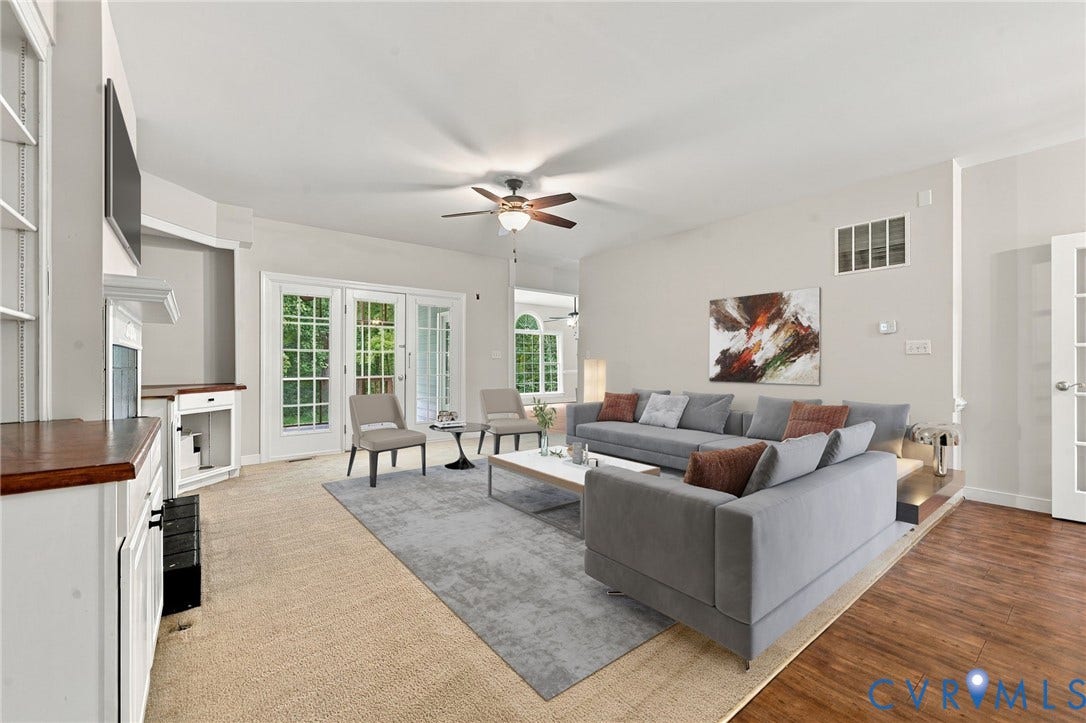 2654 Academy Road, Powhatan, VA 23139 Living area featuring neutral carpeting, LVP flooring, a ceiling fan with light kit, a built-in cabinet with a wood countertop, and multi-pane glass doors. Virtually staged concept