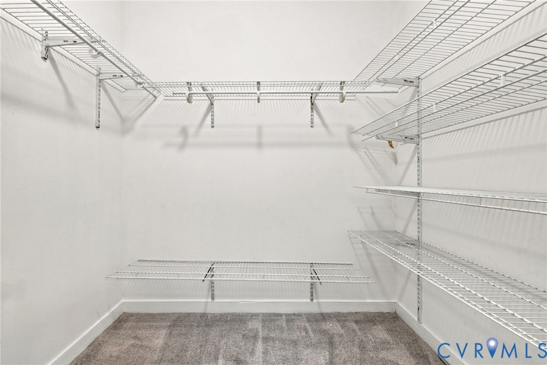 2654 Academy Road, Powhatan, VA 23139 Walk-in storage space featuring white wire shelving, wall-mounted supports, and neutral carpeting