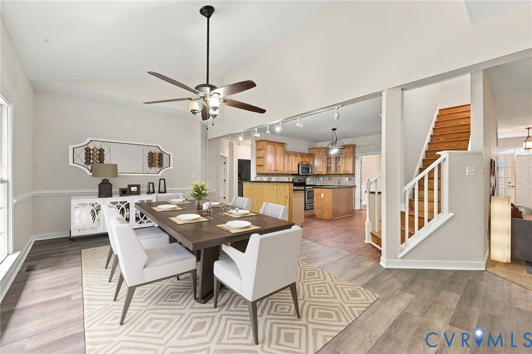 2654 Academy Road, Powhatan, VA 23139 Dining area featuring LVP flooring, a raised sloped ceiling, a multi-blade ceiling fan with integrated lighting, and a triple-pane window with an arched transom. Virtually staged concept
