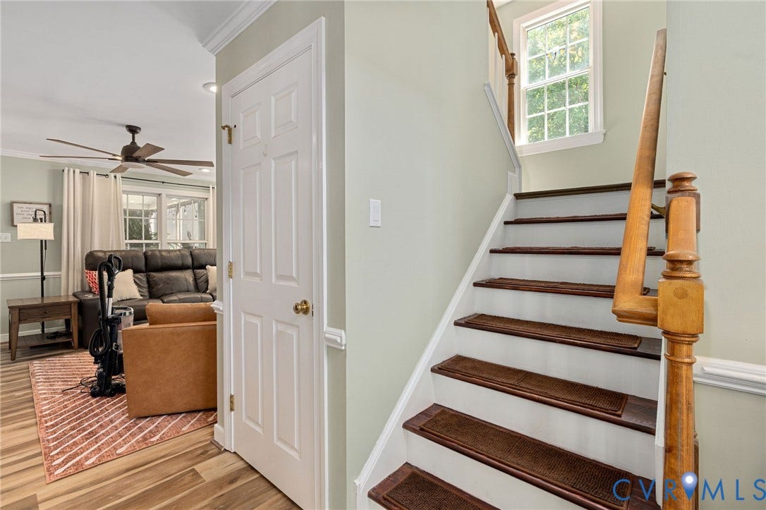 4427 Tweedsmuir Court, Midlothian, VA 23120 Staircase featuring white risers, wood-finish treads, and a traditional wood banister, complemented by a multi-pane window and crown molding