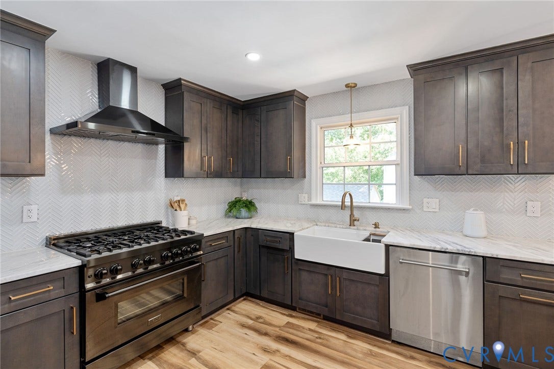 4427 Tweedsmuir Court, Midlothian, VA 23120 Kitchen featuring charcoal-toned shaker cabinetry, stone-finish countertops, a white farmhouse-style sink, stainless steel professional-grade range, and herringbone-pattern tile backsplash