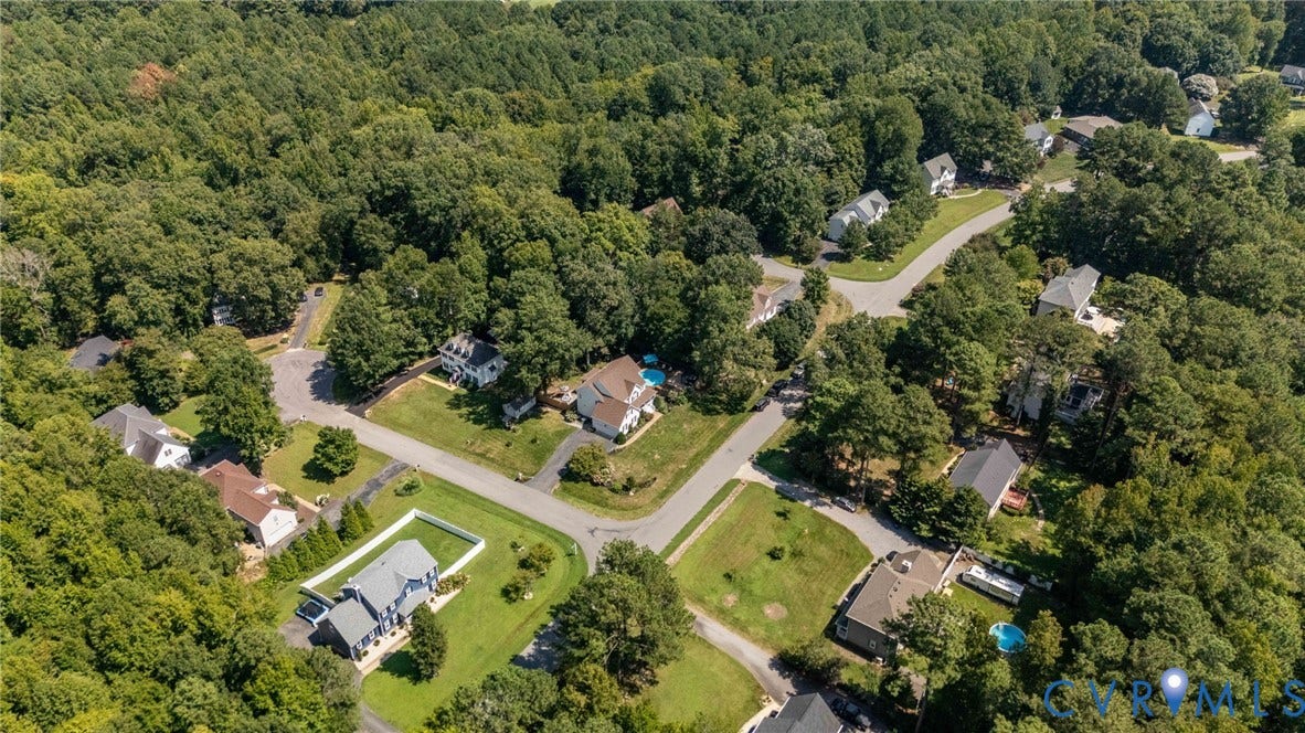 4427 Tweedsmuir Court, Midlothian, VA 23120 Aerial perspective of a residential neighborhood characterized by established tree canopy, paved roads, and manicured lawns