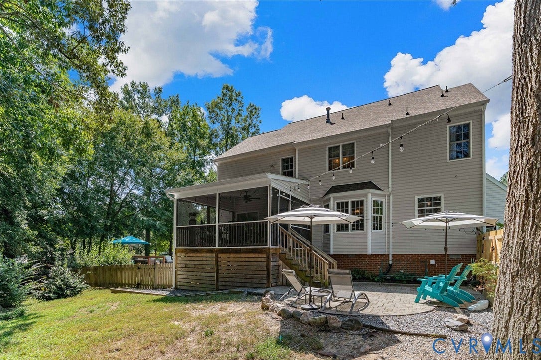 4427 Tweedsmuir Court, Midlothian, VA 23120 Rear exterior featuring light-toned horizontal siding, a brick foundation, a screened-in porch with wood-finish decking, and a paver stone patio
