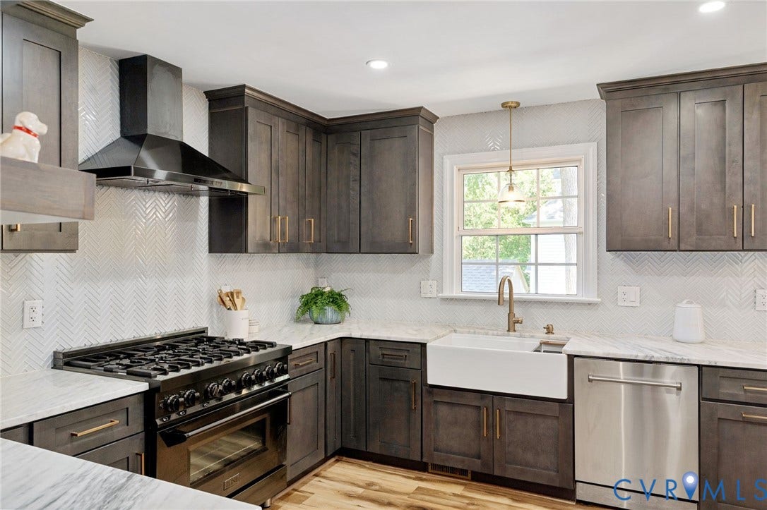 4427 Tweedsmuir Court, Midlothian, VA 23120 Kitchen featuring dark-stained shaker cabinetry, stone countertops, a white farmhouse sink with a brass-finish faucet, herringbone-patterned tile backsplash, and stainless steel professional-style range with matching hood