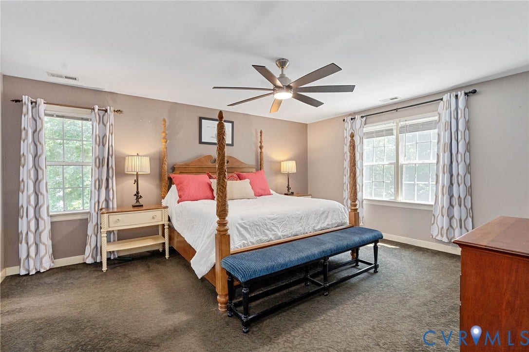 4427 Tweedsmuir Court, Midlothian, VA 23120 Neutral-toned walls, expansive windows with dual-rod drapery hardware, plush carpeting, and a multi-blade ceiling fan with integrated lighting