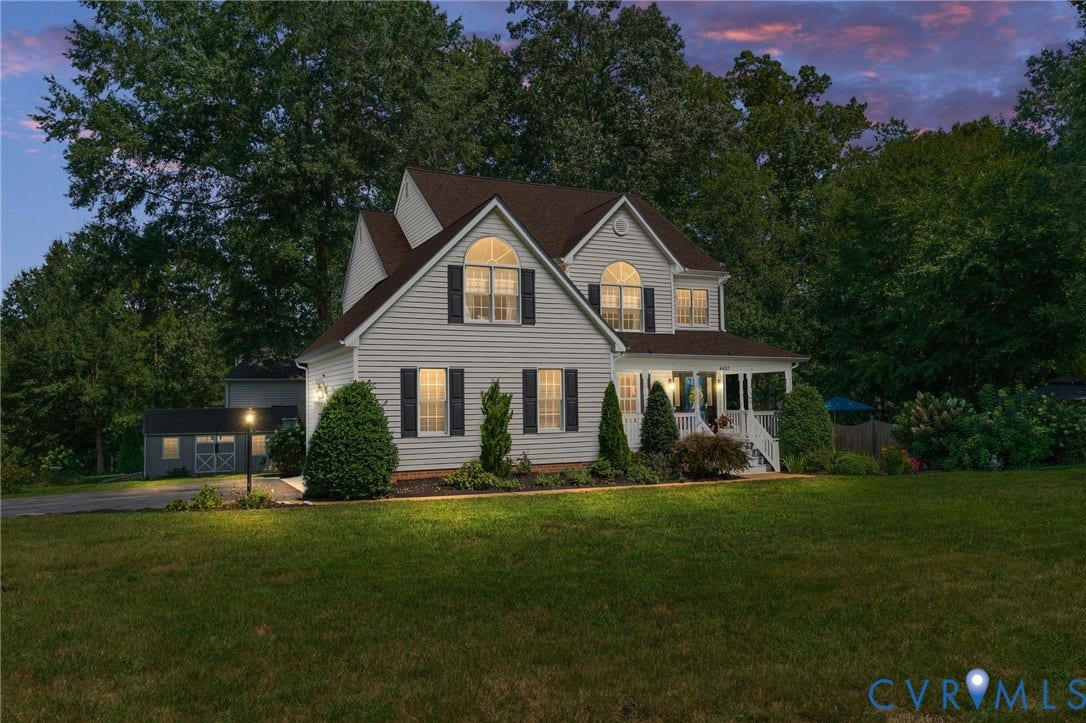 4427 Tweedsmuir Court, Midlothian, VA 23120 Two-story residence featuring horizontal siding, arched windows, a covered front porch, and a detached outbuilding