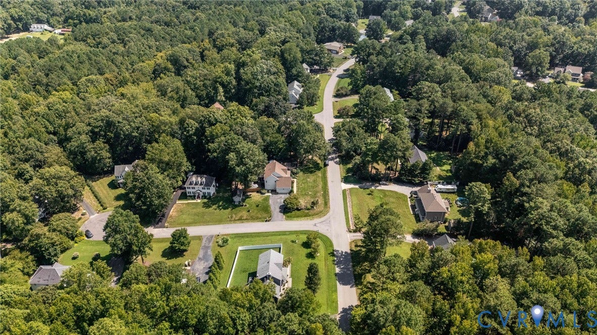 4427 Tweedsmuir Court, Midlothian, VA 23120 Aerial perspective of a residential neighborhood featuring mature tree canopy, paved streets, and varied lot sizes