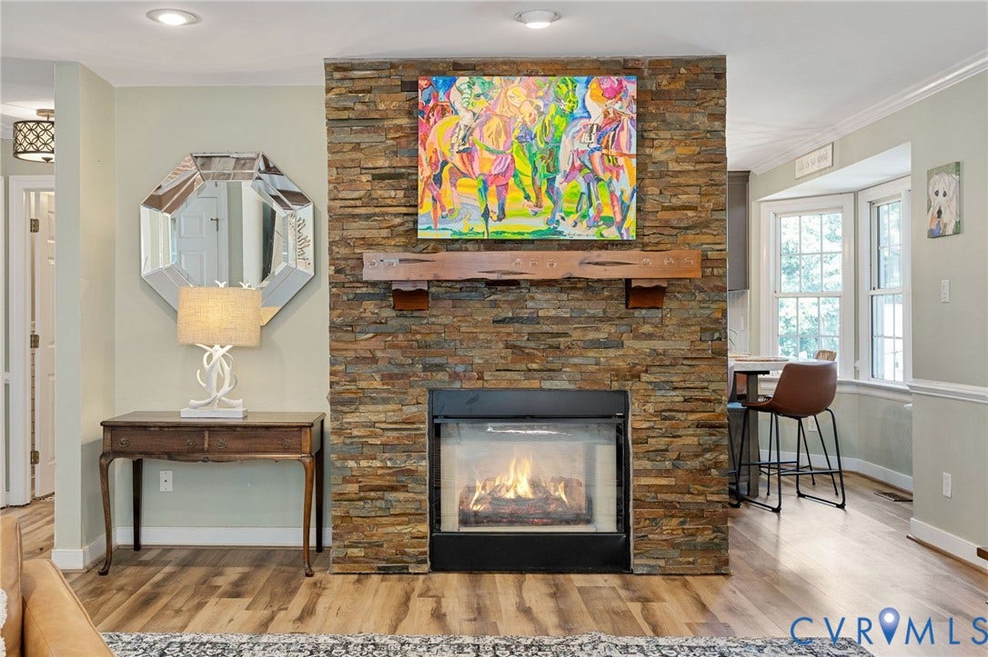 4427 Tweedsmuir Court, Midlothian, VA 23120 Floor-to-ceiling stone fireplace with a prominent timber mantel, recessed ceiling lighting, and wood-finish flooring